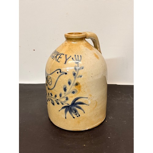 147 - Stoneware Whiskey flagon decorated with a bird in a floral composition.

15 cm high overall.

This l... 