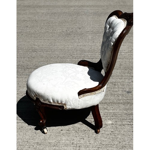 133 - Victorian upholstered nursing chair, with a carved mahogany frame.

This lot is collection only