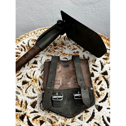 306 - Militaria, a US made Vietnam era three position shovel and leather storage pouch.

This lot is avail... 