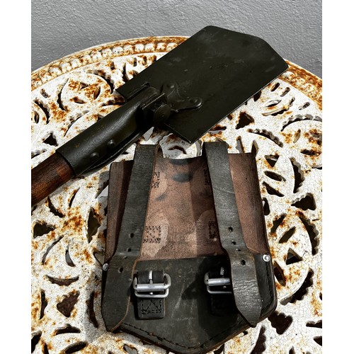 306 - Militaria, a US made Vietnam era three position shovel and leather storage pouch.

This lot is avail... 