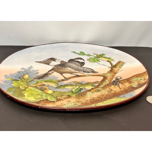 42 - Oval form wall hanging charger decorated with a natural history study, Birds beetle and fauna. 39 cm... 