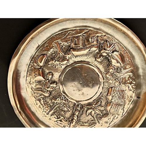 54 - Embossed and plated dish decorated with Indian scenes.

This lot is available for in-house shipping