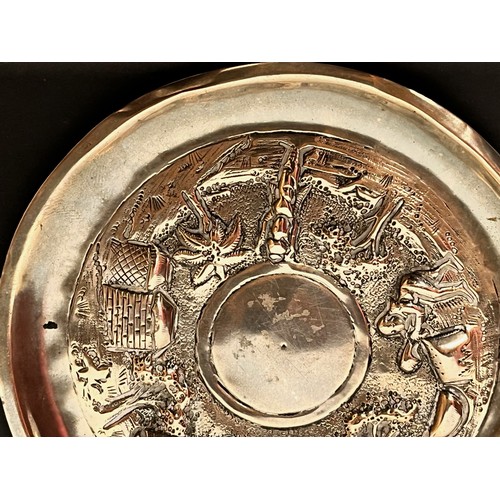 54 - Embossed and plated dish decorated with Indian scenes.

This lot is available for in-house shipping