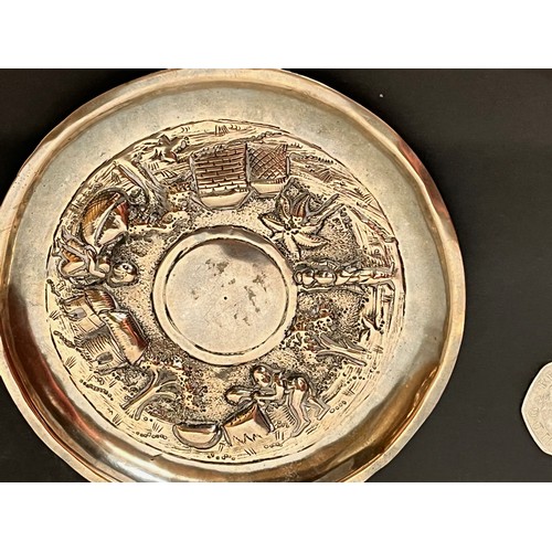 54 - Embossed and plated dish decorated with Indian scenes.

This lot is available for in-house shipping