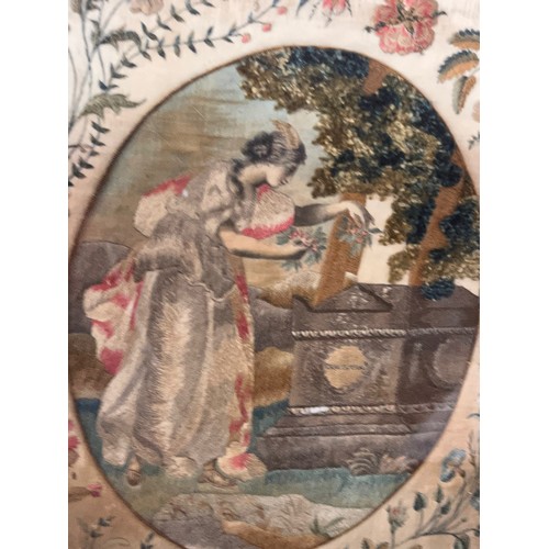 78 - Framed C19th stumpwork embroidery panel classical maiden laying a gift on a tomb, 48 cm x 38 cm.

Th... 