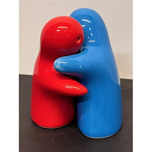 423 - Mid century Kitsch, a pair of salt and pepper pots modelled as hugging figures.

In house shipment i... 