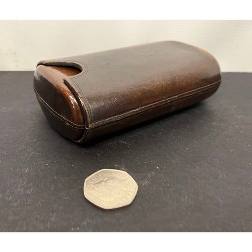 44 - Leather cigar case with a couple of residents included. 5 inches long when fully closed.

This lot i... 
