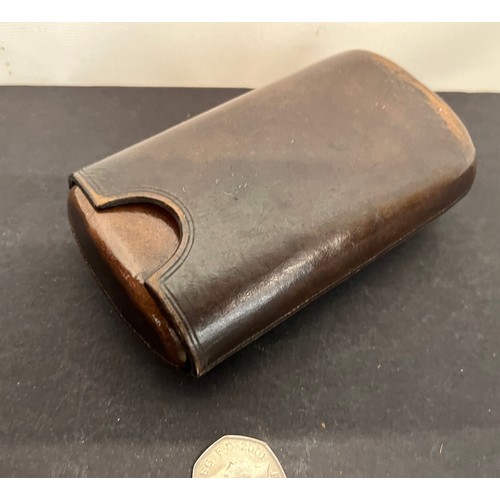 44 - Leather cigar case with a couple of residents included. 5 inches long when fully closed.

This lot i... 