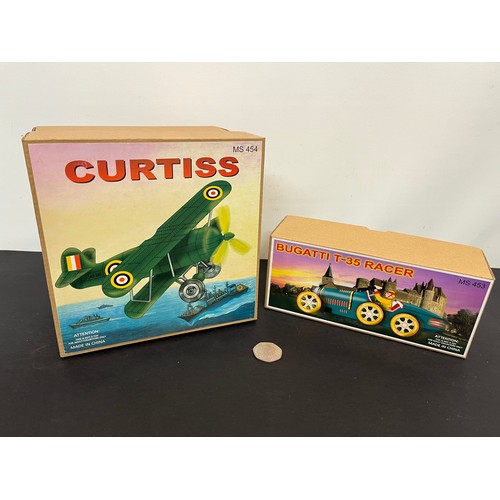 43 - Tin plate toy Bugatti racing car and a Curtis WWI era fighter, bothe boxed.

This lot is available f... 