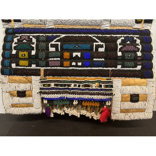 8 - Tribal art, a bead work on leather panel.

This lot is available for in-house shipping