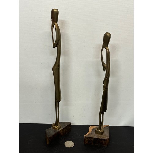 17 - A pair of contemporary cast brass African figures mounted on wooden stands. 30 cm and 35 cm tall .

... 