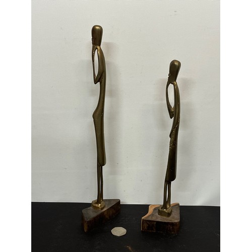 17 - A pair of contemporary cast brass African figures mounted on wooden stands. 30 cm and 35 cm tall .

... 