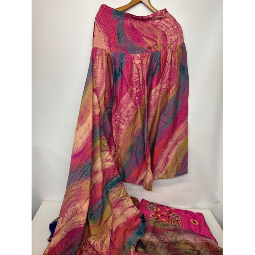 107 - Clothing, a collection of Indian skirts, coats etc.

This lot is available for in-house shipping