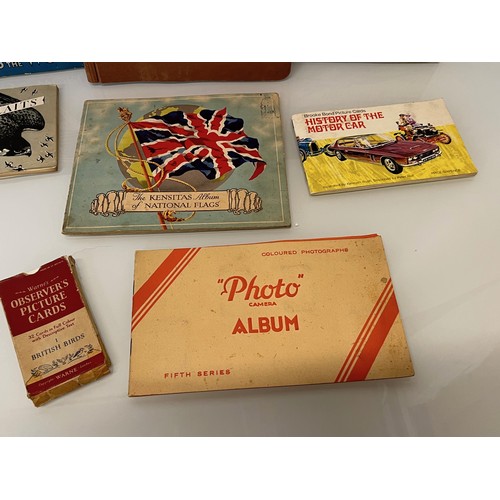 117 - Ephemera, cigarette cards and trade cards, a collection in seven albums and a packet as shown.

This... 