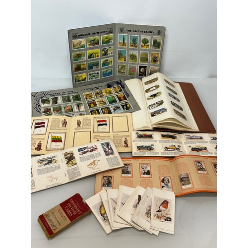 117 - Ephemera, cigarette cards and trade cards, a collection in seven albums and a packet as shown.

This... 