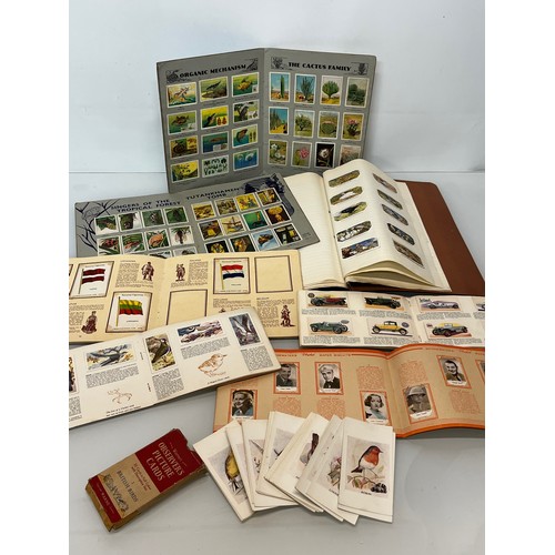 117 - Ephemera, cigarette cards and trade cards, a collection in seven albums and a packet as shown.

This... 