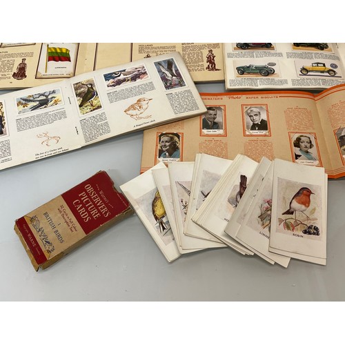 117 - Ephemera, cigarette cards and trade cards, a collection in seven albums and a packet as shown.

This... 