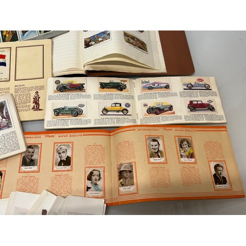 117 - Ephemera, cigarette cards and trade cards, a collection in seven albums and a packet as shown.

This... 