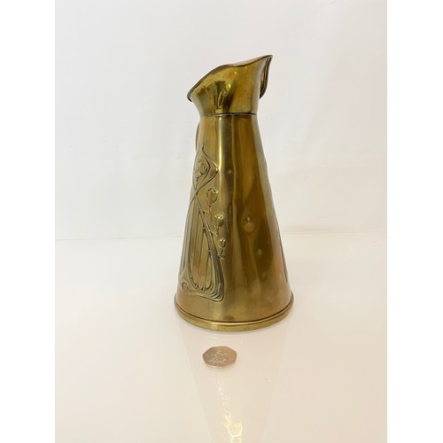 126 - Brass jug with embossed art nouveau decoration. 

This lot is available for in-house shipping