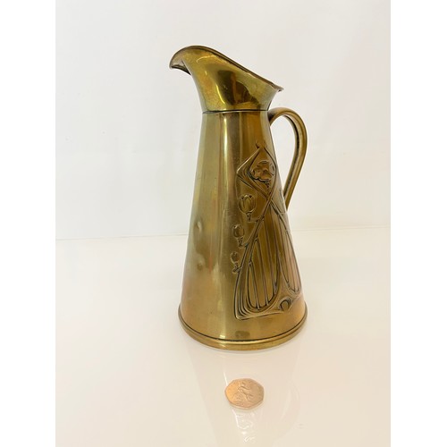 126 - Brass jug with embossed art nouveau decoration. 

This lot is available for in-house shipping