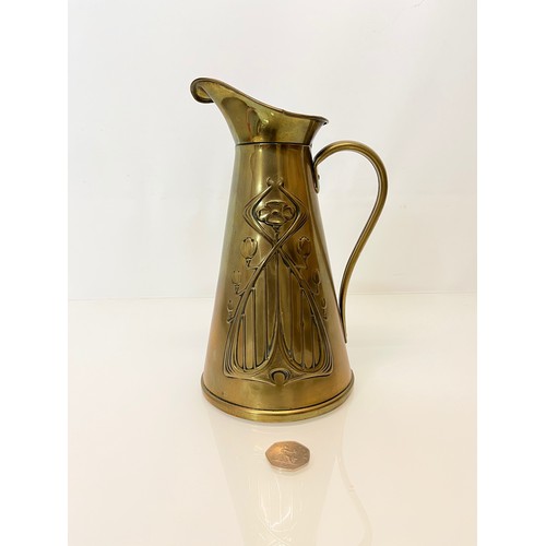 126 - Brass jug with embossed art nouveau decoration. 

This lot is available for in-house shipping