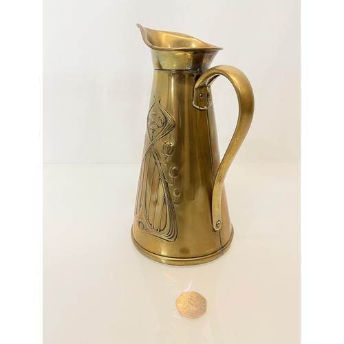 126 - Brass jug with embossed art nouveau decoration. 

This lot is available for in-house shipping