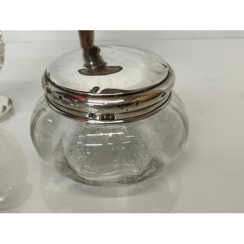 143 - Mixed silver wares, lidded jar, stem vase, glass vase, and silver rimmed vase.

This lot is availabl... 