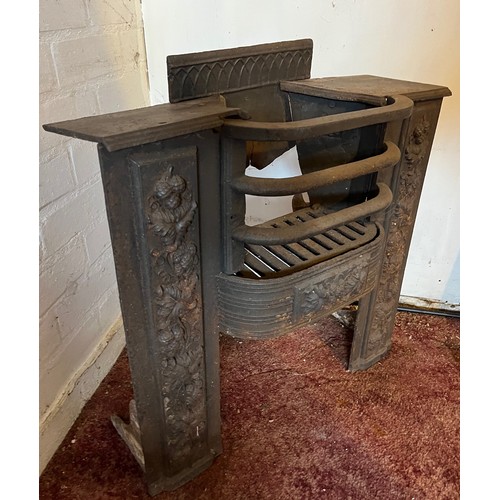 194 - Architectural salvage, decorated cast iron fire front with a raised hearth section. 22 inches wide x... 