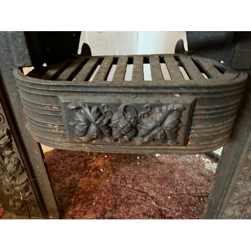 194 - Architectural salvage, decorated cast iron fire front with a raised hearth section. 22 inches wide x... 