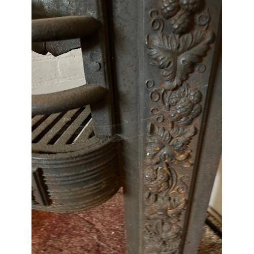 194 - Architectural salvage, decorated cast iron fire front with a raised hearth section. 22 inches wide x... 