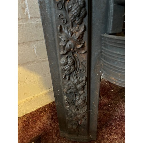 194 - Architectural salvage, decorated cast iron fire front with a raised hearth section. 22 inches wide x... 