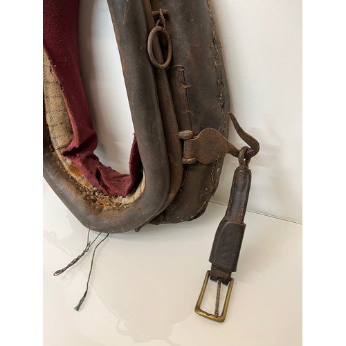 212 - Equestrian farming equipment, a horse collar with brass and wrought iron fittings.

This lot is avai... 