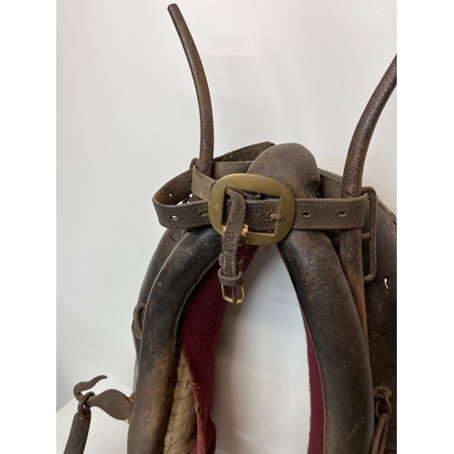 212 - Equestrian farming equipment, a horse collar with brass and wrought iron fittings.

This lot is avai... 