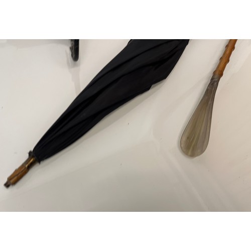 214 - Shooting stick with folding seat an umbrella and a shoe horn.

This lot is available for in-house sh... 