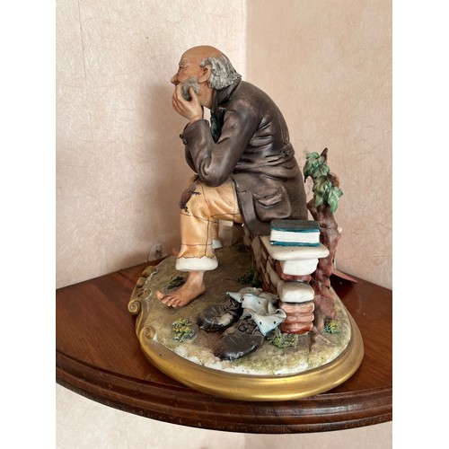 234 - NAO figurine of a seated tramp.

This lot is available for in-house shipping