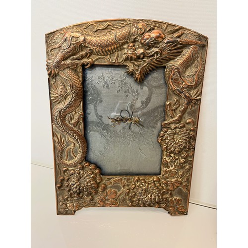 367 - Two Oriental plated copper picture frames embossed with dragons and flowers.

This lot is available ... 