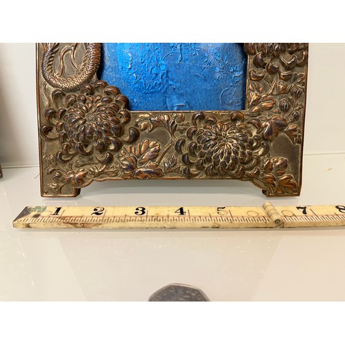 367 - Two Oriental plated copper picture frames embossed with dragons and flowers.

This lot is available ... 