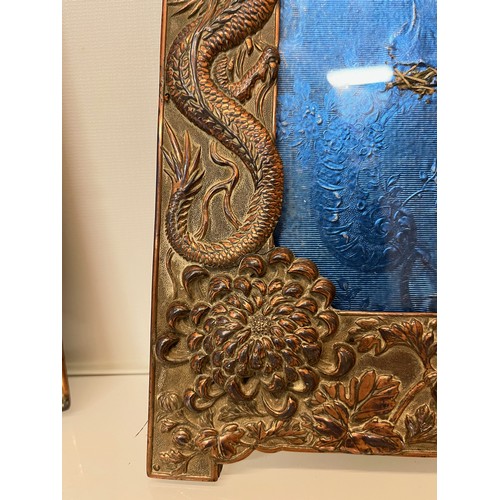 367 - Two Oriental plated copper picture frames embossed with dragons and flowers.

This lot is available ... 