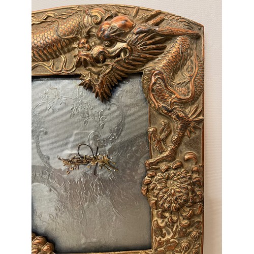 367 - Two Oriental plated copper picture frames embossed with dragons and flowers.

This lot is available ... 