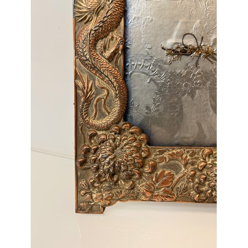 367 - Two Oriental plated copper picture frames embossed with dragons and flowers.

This lot is available ... 