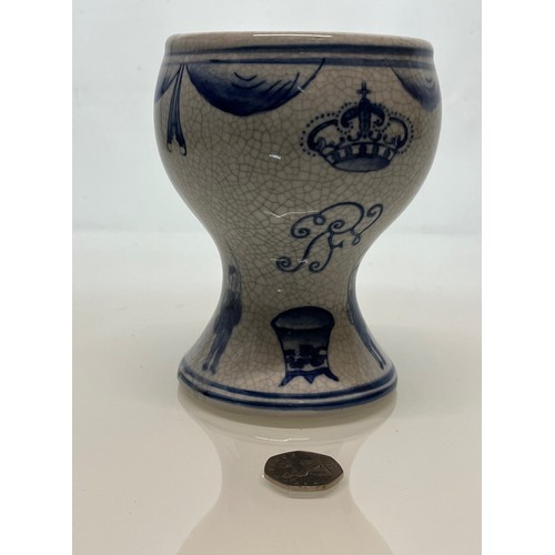 446 - A decorative crackle glazed vase with illustrations of fisherman around the base above these are a m... 