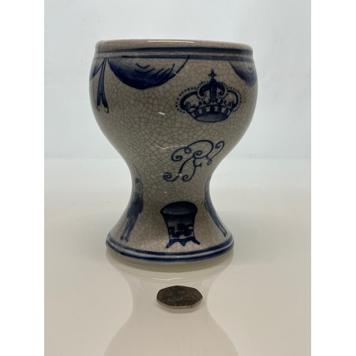 446 - A decorative crackle glazed vase with illustrations of fisherman around the base above these are a m... 