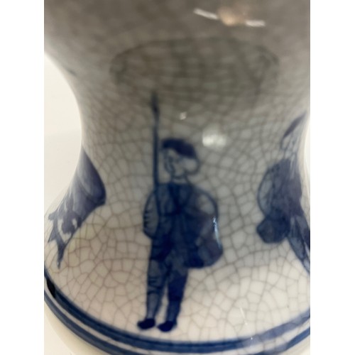 446 - A decorative crackle glazed vase with illustrations of fisherman around the base above these are a m... 