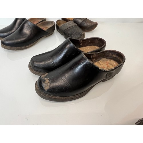 146 - A collection of early C20th working shoes, wooden soled clogs for all members of a family.

This lot... 