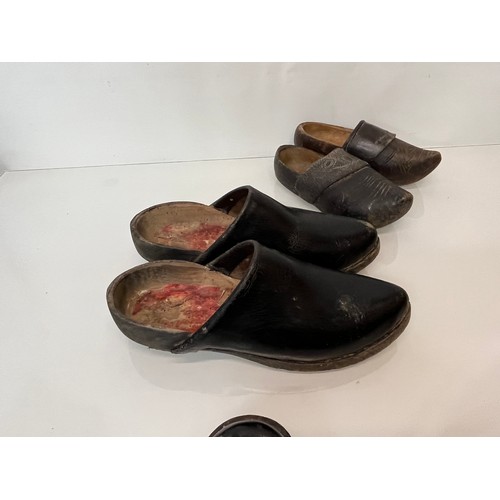 146 - A collection of early C20th working shoes, wooden soled clogs for all members of a family.

This lot... 