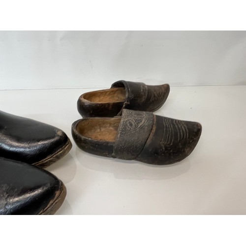 146 - A collection of early C20th working shoes, wooden soled clogs for all members of a family.

This lot... 