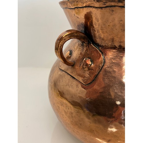 157 - Decorative hand made art nouveau copper two handled pot. 20 cm high

This lot is available for in-ho... 