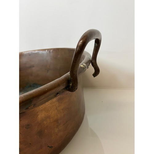 158 - Kitchenalia, a large two two handled copper bowl 48 cm in diameter and 27 cm thigh to the top of the... 