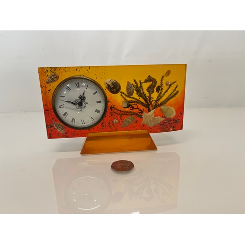 398 - Mid century mantle clock with a coloured Lucite body encapsulating sea shells etc. 19 cm x 12 cm x 2... 