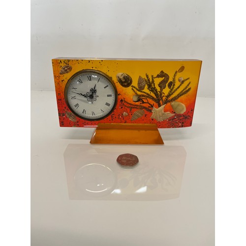 398 - Mid century mantle clock with a coloured Lucite body encapsulating sea shells etc. 19 cm x 12 cm x 2... 